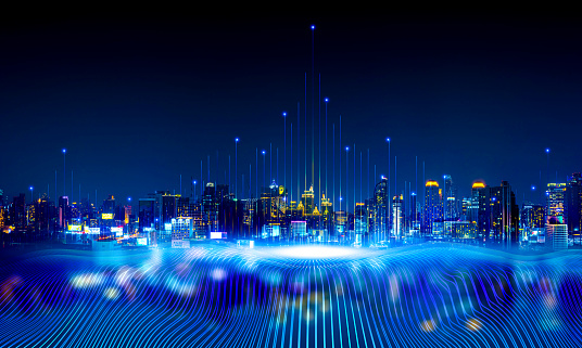 A nighttime city skyline overlaid with glowing vertical data lines and a bottom wave of digital light streams.