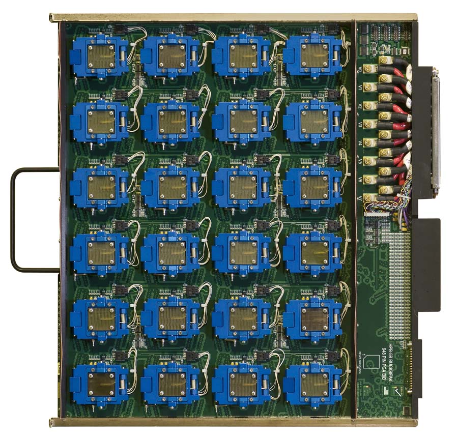 A circuit board containing twenty-four blue processor sockets arranged in a grid, with a handle on the left and a connector port on the right.